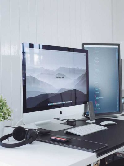 photo of a computer with a wide screen on a modern desk